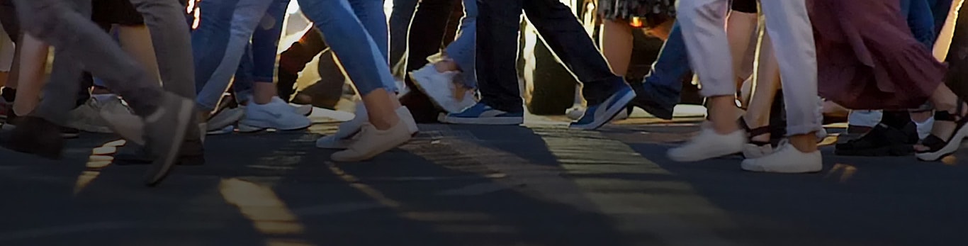 Passage piéton illustrant des dizaines de personnes marchant dans des directions opposées lorsqu’elles traversent la rue