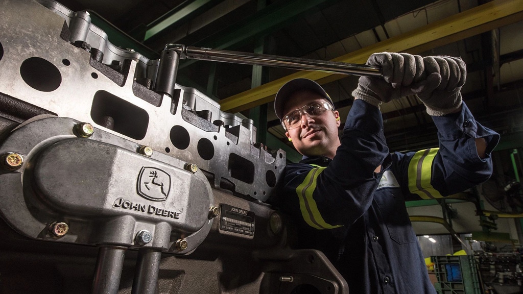technicien utilisant une clé sur un moteur