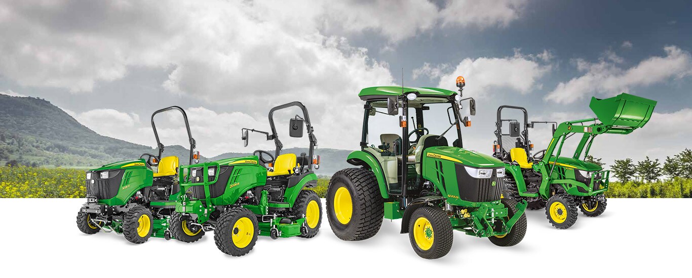 Paysage avec groupe de tracteurs utilitaires compacts